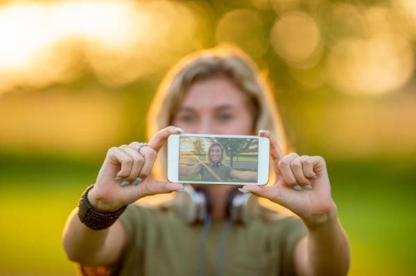 Girl holding camera | i2i Marketing